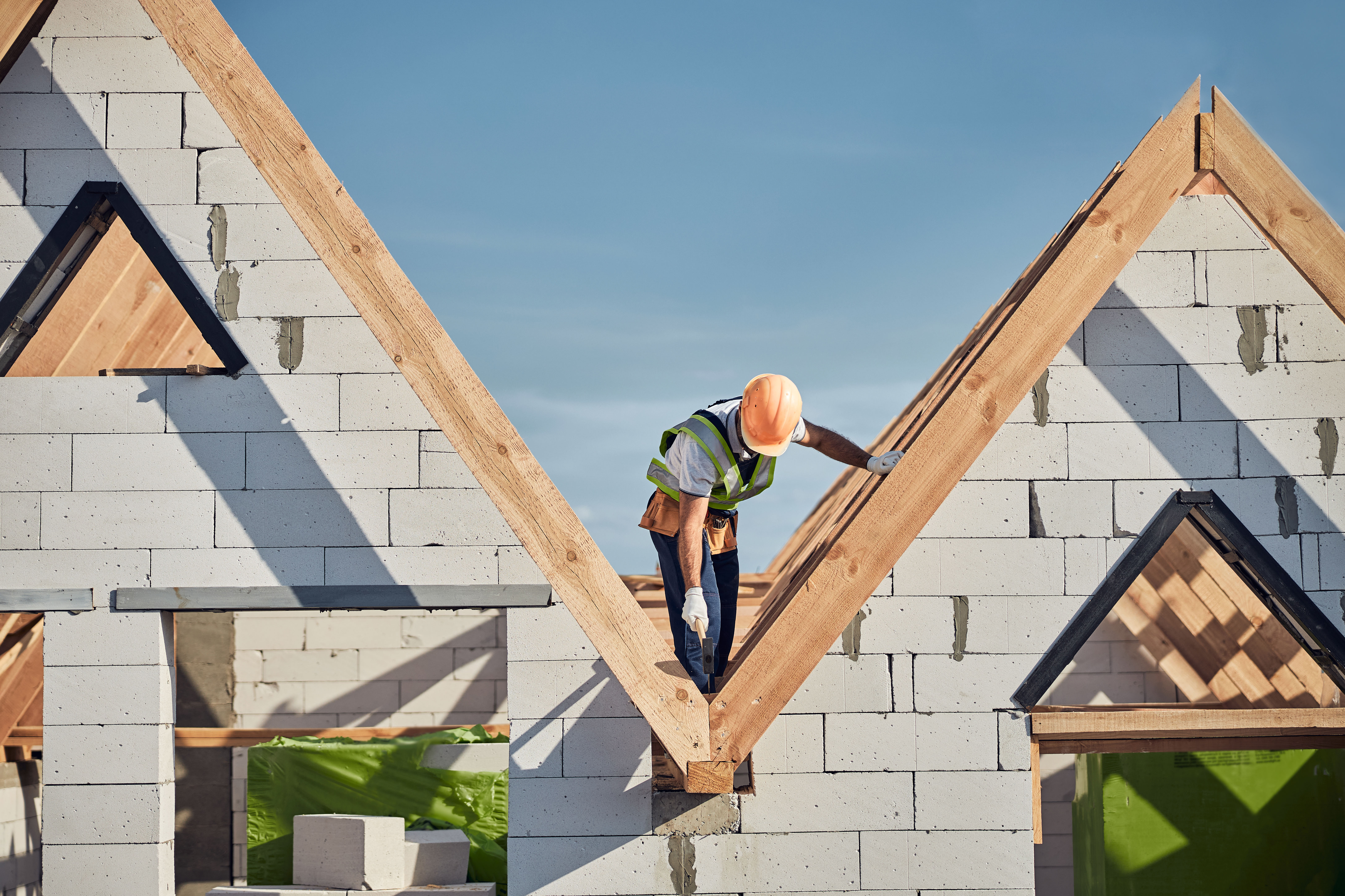 Construction lead inspecting a roof