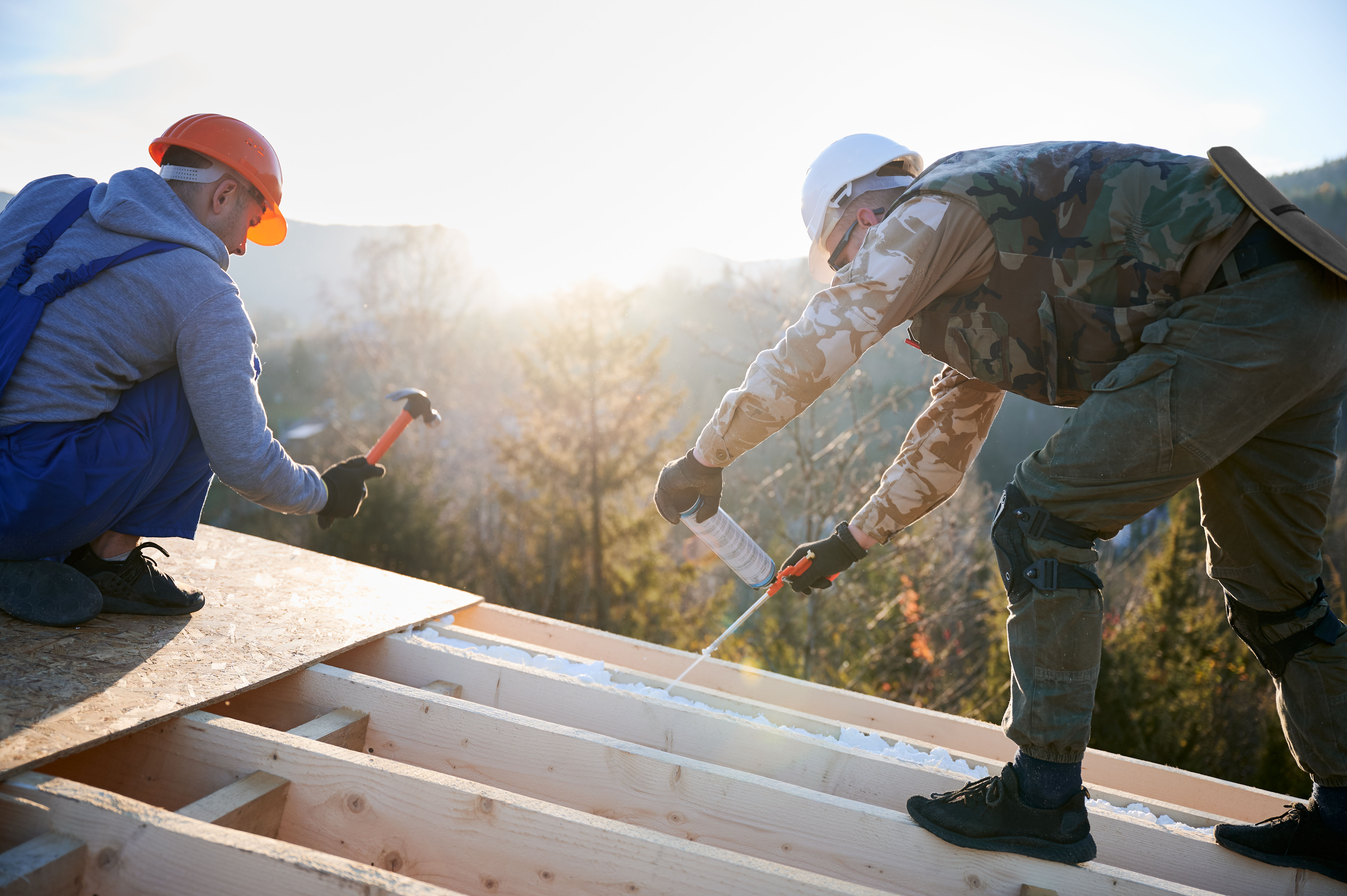 Installer adding insulation to a roof